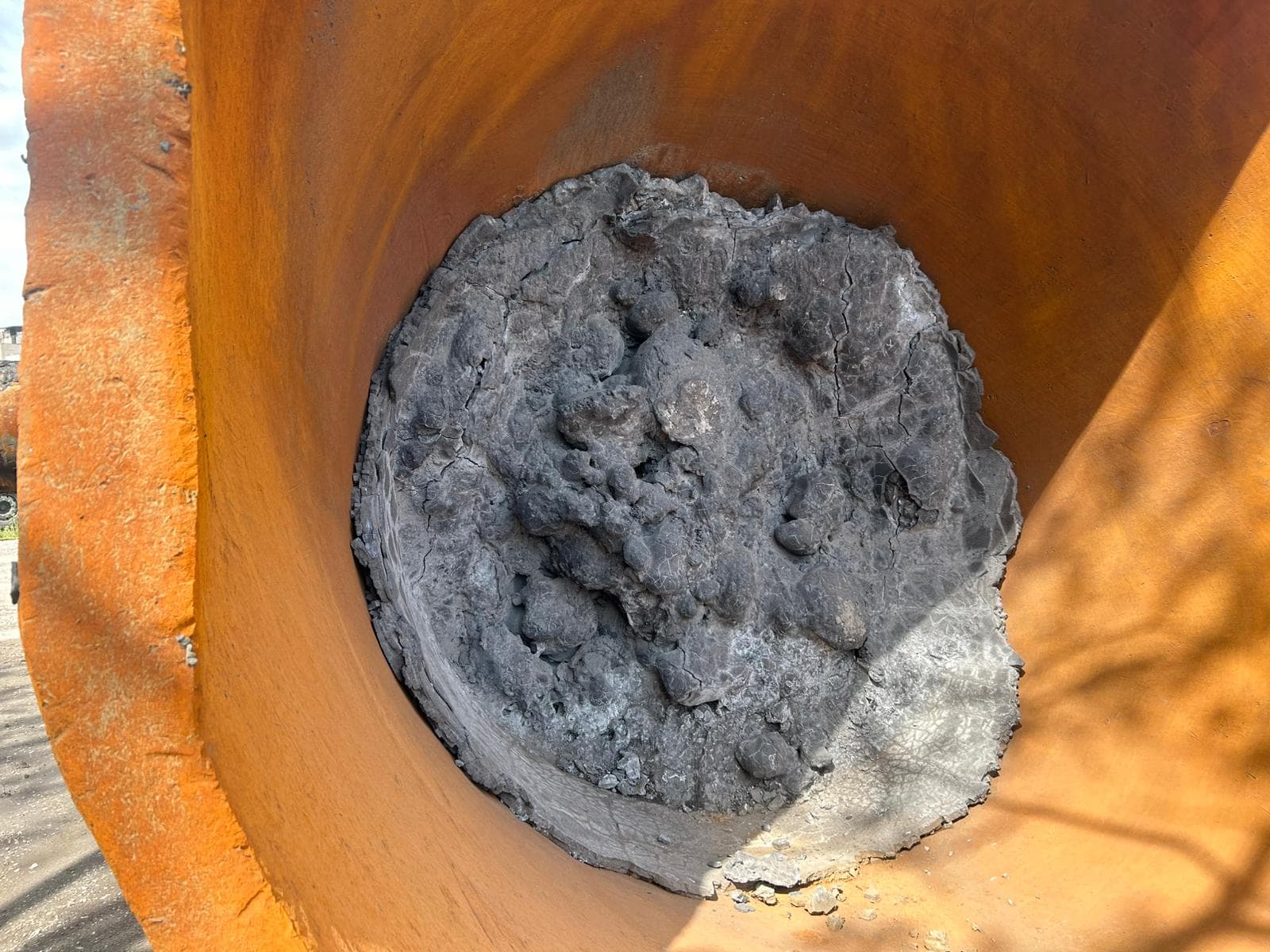 Close-up of solidified slag residue inside a slag pot