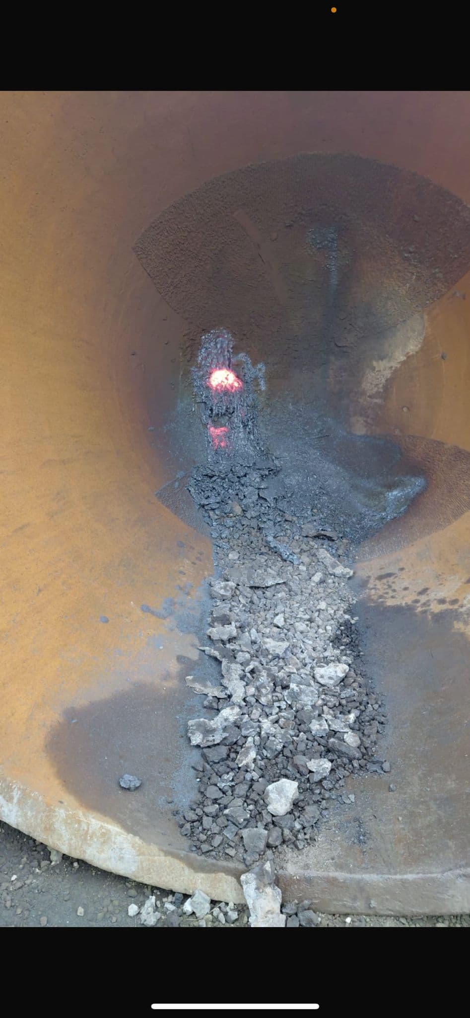 Slag pot interior during active gouging with glowing hot spot